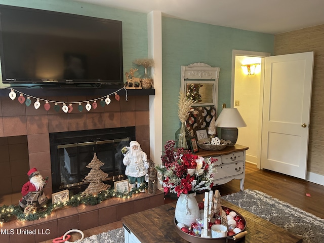 living room featuring hardwood / wood-style floors and a tile fireplace