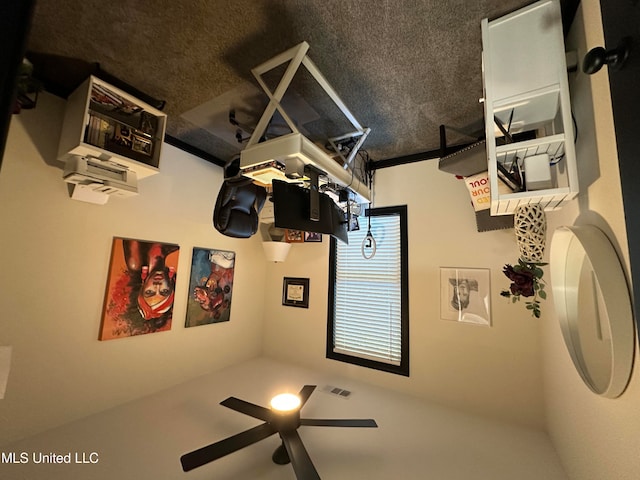 interior space featuring a textured ceiling and ceiling fan