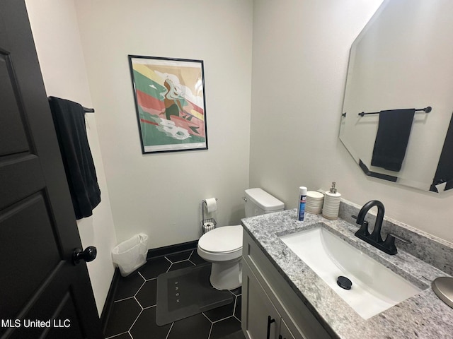 bathroom featuring tile patterned floors, vanity, and toilet