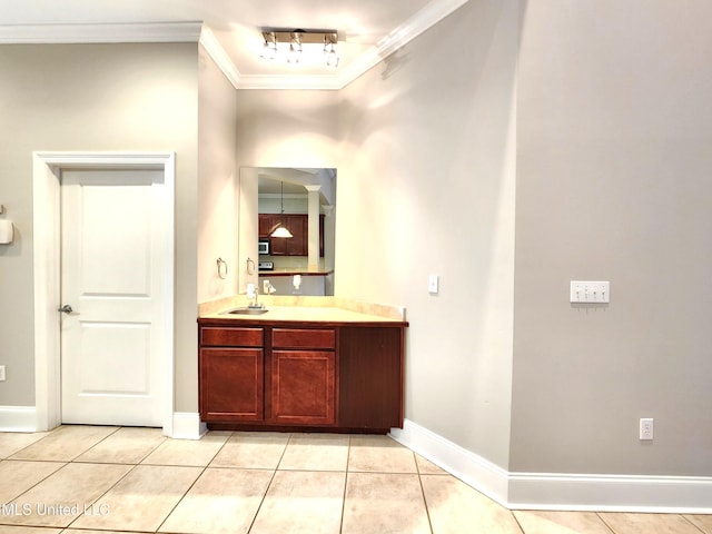 bathroom with vanity, crown molding, and tile patterned floors