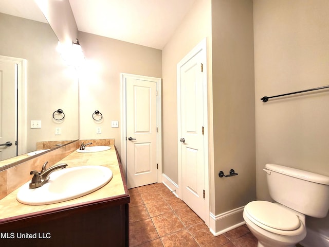 bathroom featuring vanity, tile patterned floors, and toilet