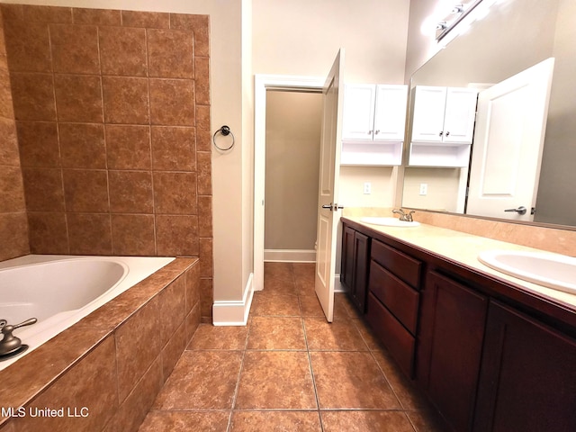 bathroom with tiled bath and vanity