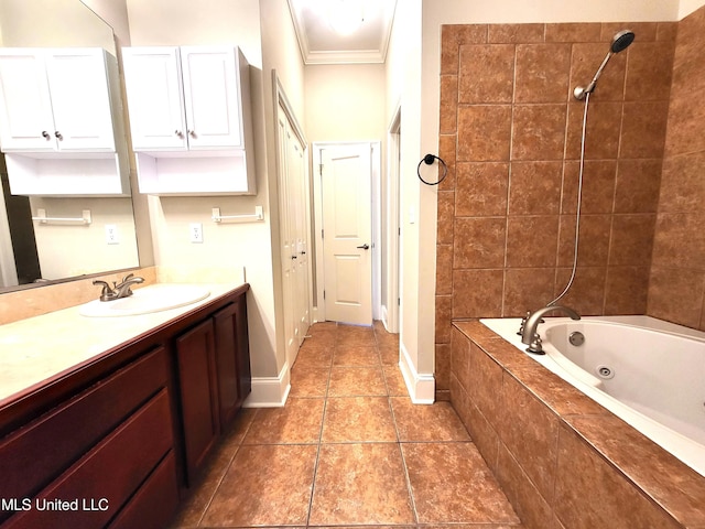 bathroom featuring tiled shower / bath, ornamental molding, and vanity