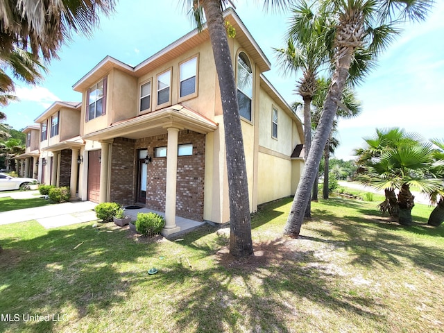 view of front facade with a front lawn and a garage