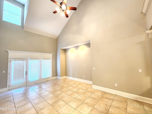 unfurnished living room with high vaulted ceiling, ceiling fan, and light tile patterned floors