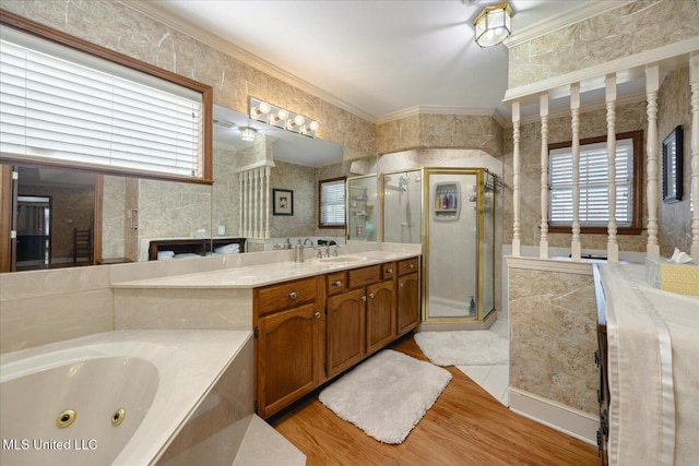 bathroom with wood-type flooring, vanity, separate shower and tub, and ornamental molding