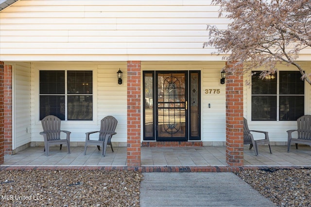 view of exterior entry with a porch