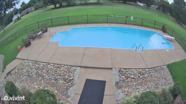 view of swimming pool with a diving board