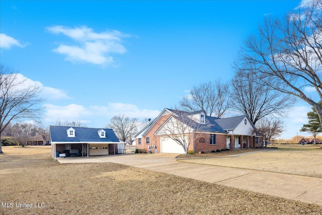 cape cod house with a carport and a front yard