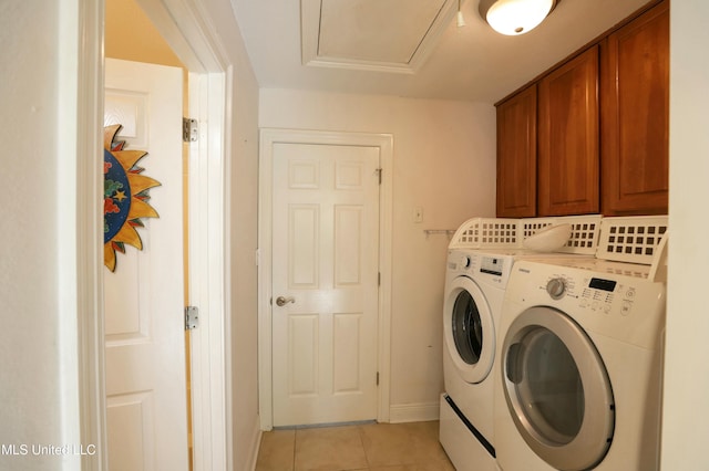 laundry area featuring light tile patterned flooring, cabinets, and separate washer and dryer