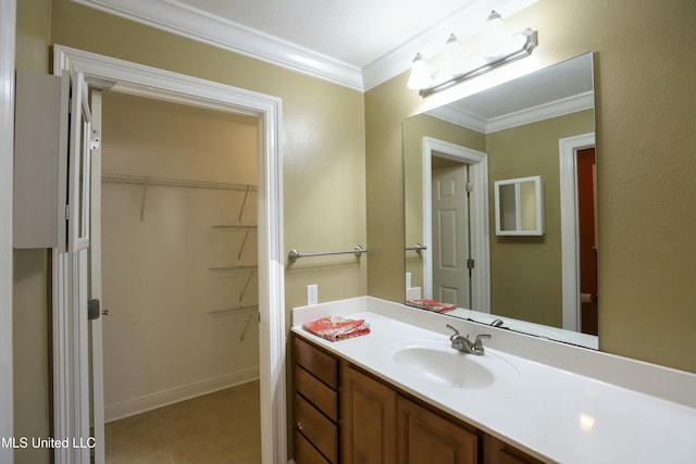 63720 N Diamondhead Dr, Diamondhead, MS 39525 - bathroom featuring vanity, ornamental molding, tile patterned flooring, and a spacious closet