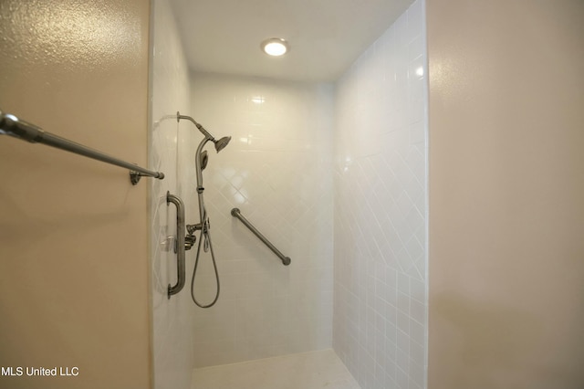 bathroom with tiled shower