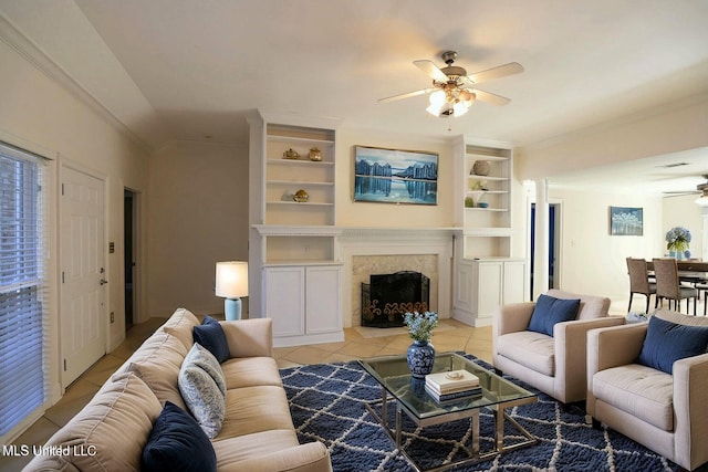63720 N Diamondhead Dr, Diamondhead, MS 39525 - living area featuring ceiling fan, light tile patterned flooring, crown molding, a premium fireplace, and built in features