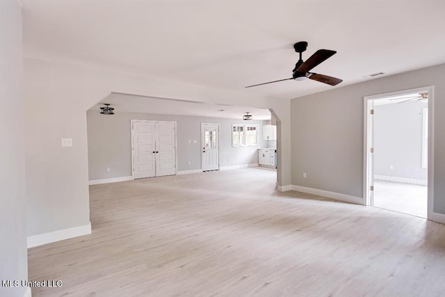 unfurnished living room featuring ceiling fan and light hardwood / wood-style floors