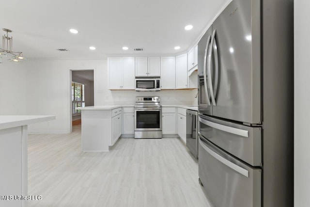 kitchen featuring visible vents, light countertops, light wood-style flooring, appliances with stainless steel finishes, and white cabinetry