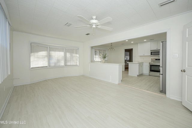 unfurnished living room with baseboards, light wood finished floors, visible vents, and a ceiling fan