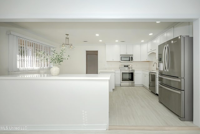 kitchen featuring visible vents, stainless steel appliances, light countertops, white cabinetry, and recessed lighting