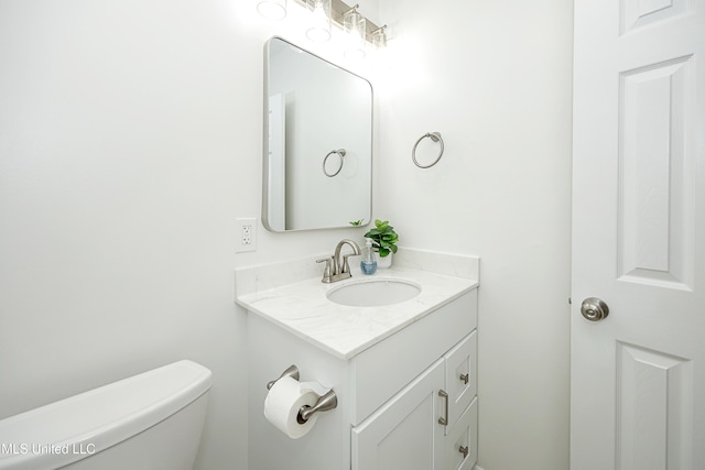 half bath featuring toilet and vanity