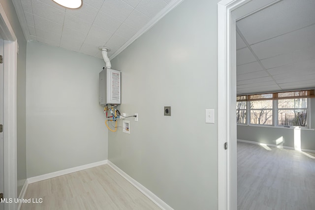 clothes washing area with hookup for a washing machine, electric dryer hookup, wood finished floors, laundry area, and baseboards