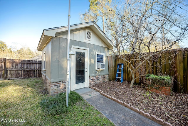 view of outbuilding with an outdoor structure, a fenced backyard, and cooling unit