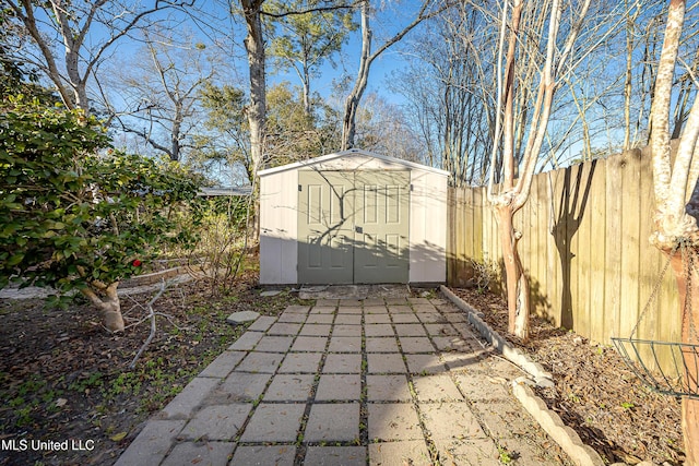 view of shed featuring fence