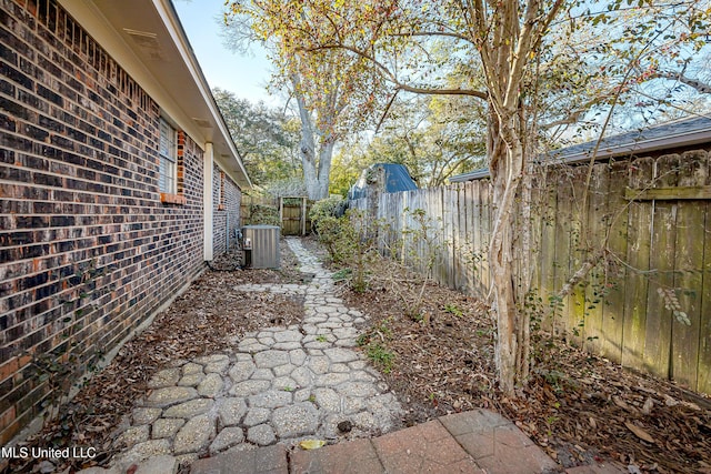 view of yard featuring a fenced backyard and central AC