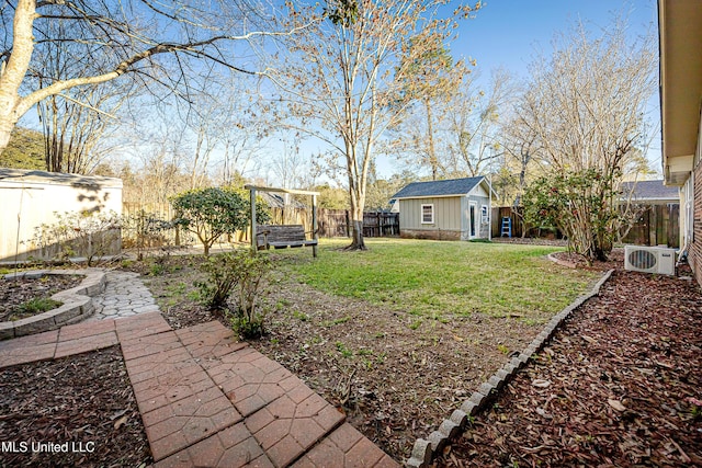 view of yard with an outbuilding, a fenced backyard, and ac unit