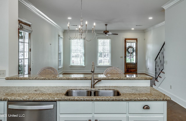 kitchen featuring stainless steel dishwasher, crown molding, sink, and light stone counters