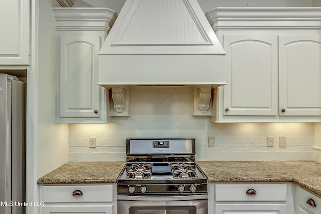 kitchen with premium range hood, stainless steel appliances, white cabinets, and tasteful backsplash