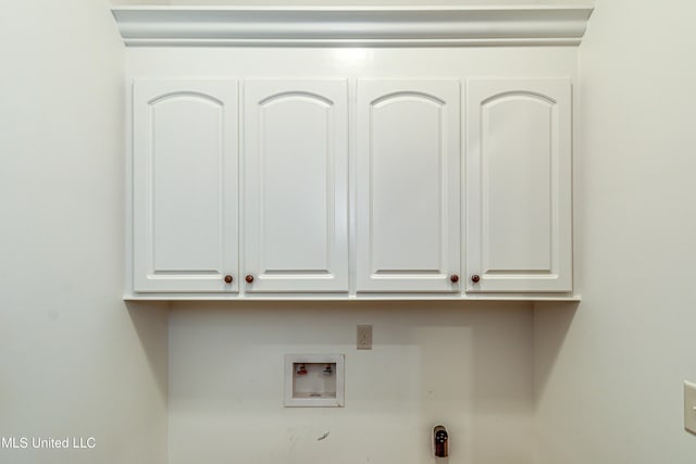 washroom with washer hookup and cabinets