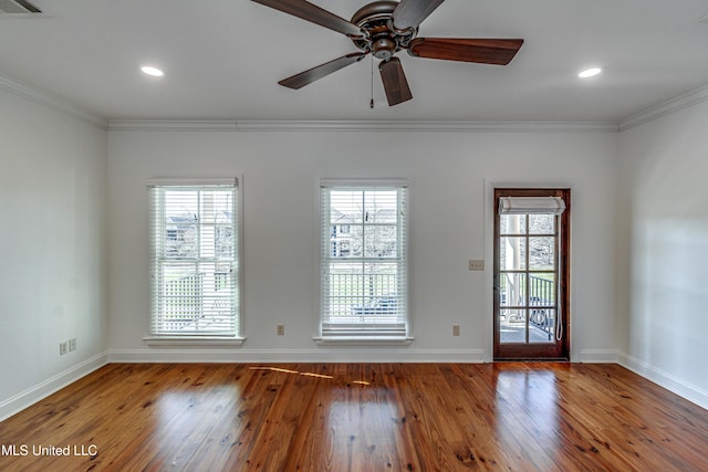 spare room with ceiling fan, ornamental molding, and hardwood / wood-style flooring