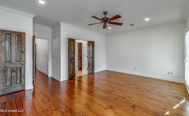 spare room with hardwood / wood-style flooring, ornamental molding, and ceiling fan