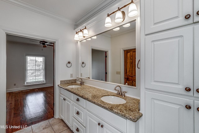 bathroom featuring ceiling fan, vanity, tile patterned flooring, and ornamental molding