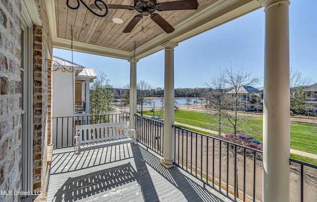 wooden terrace featuring ceiling fan and a water view