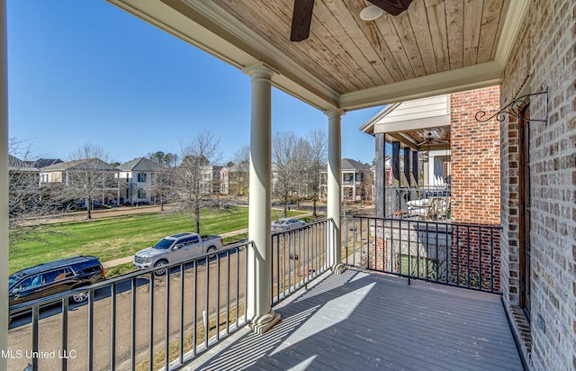 wooden terrace with ceiling fan and covered porch