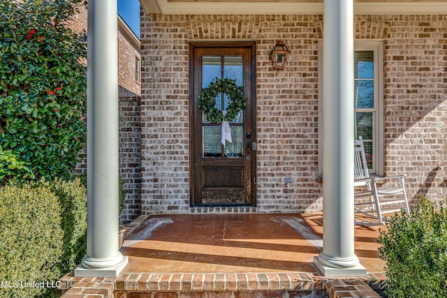 view of exterior entry with covered porch