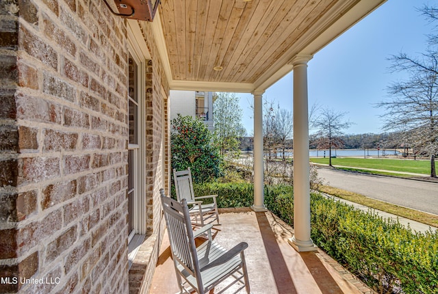 view of patio with a water view