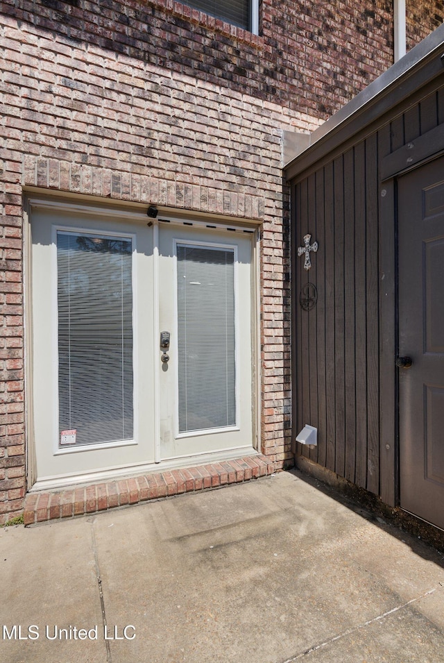 entrance to property with brick siding