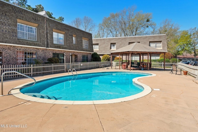 view of swimming pool featuring a patio, a gazebo, fence, and a fenced in pool