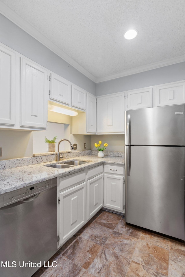 kitchen with white cabinetry, a sink, stainless steel appliances, and crown molding