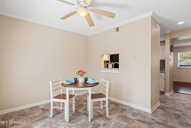 dining area with baseboards, visible vents, crown molding, and ceiling fan