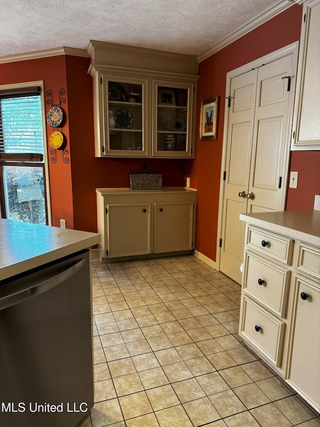 kitchen featuring light countertops, a textured ceiling, dishwasher, and light tile patterned flooring