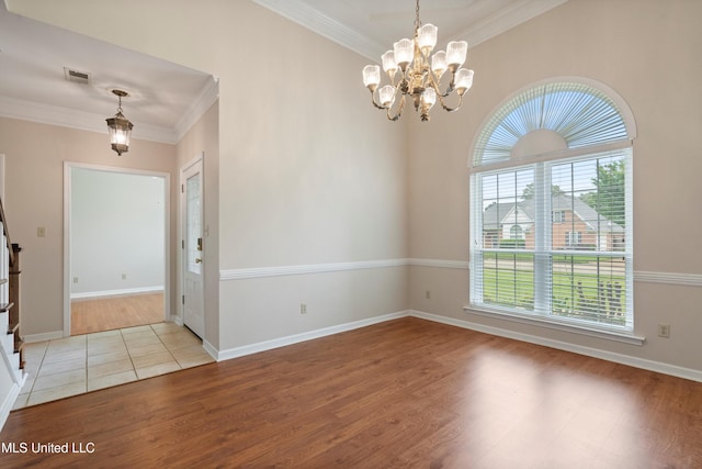 6375 Darren Dr, Olive Branch, MS 38654 - spare room with wood finished floors, a chandelier, crown molding, and baseboards