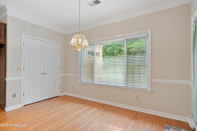 6375 Darren Dr, Olive Branch, MS 38654 - unfurnished dining area with a chandelier, light wood-type flooring, baseboards, and crown molding