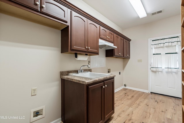 6375 Darren Dr, Olive Branch, MS 38654 - washroom featuring washer hookup, electric dryer hookup, cabinet space, light wood finished floors, and baseboards