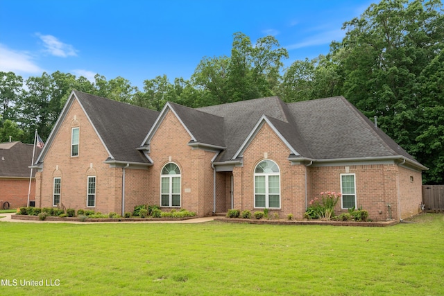 6375 Darren Dr, Olive Branch, MS 38654 - view of front facade featuring brick siding, a front yard, and roof with shingles