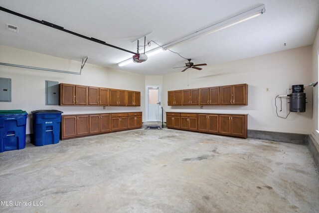 6375 Darren Dr, Olive Branch, MS 38654 - garage featuring electric panel, a garage door opener, and a central vacuum unit