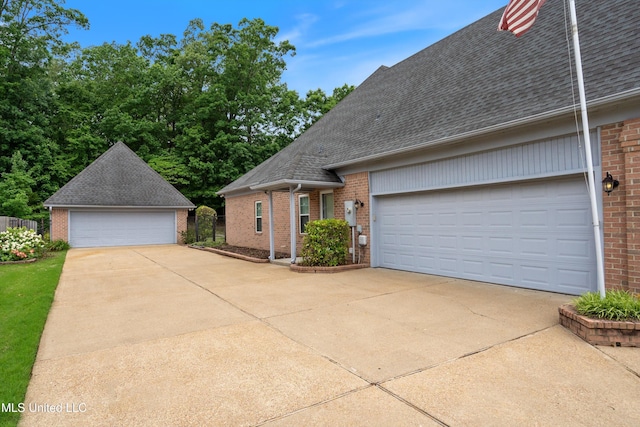6375 Darren Dr, Olive Branch, MS 38654 - view of front of property with brick siding, a garage, a shingled roof, and an outbuilding