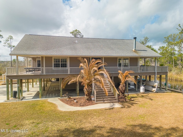 back of property featuring a yard and a patio