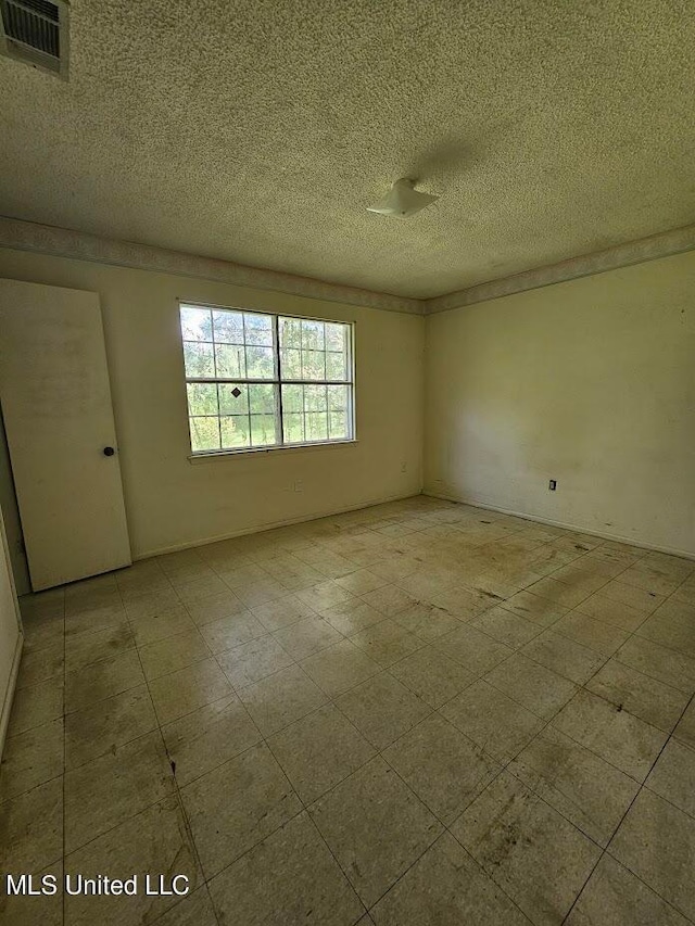 empty room featuring a textured ceiling